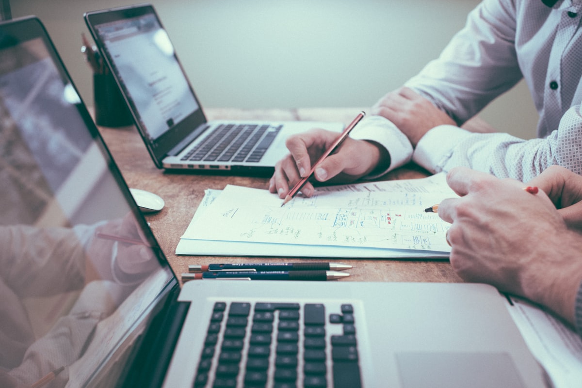 Consultant working at a laptop with notes